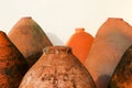 Ancient clay earthenware vessels for wine on white wall background Royalty Free Stock Photo