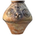 An ancient clay pot with handles with linear patterns and the image of a man Trypillia culture Royalty Free Stock Photo