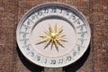 Ancient clock of Saints Apostles church in Venice with golden sun hands in the center Royalty Free Stock Photo