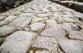 Ancient cobbled road in Pompeii, Italy. Gray granite cobblestones texture Royalty Free Stock Photo