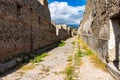 An ancient cobbled street in the ruins of Pompeii. Roman town destroyed by Vesuvius volcano Royalty Free Stock Photo