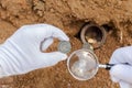 Ancient coins and magnifier.