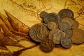 Ancient coins. Metal money of Russia and European countries against the background of an old world map. Royalty Free Stock Photo