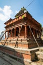 An ancient collapsing Hindu temple on a stone pedestal with wooden pillars. Durbar Square in Kathmandu, Nepal Royalty Free Stock Photo