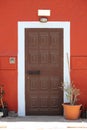 Ancient and colourful front door with flower pot Royalty Free Stock Photo