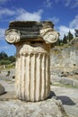 Ancient column in Ancient Greek archaeological site of Delphi, Greece Royalty Free Stock Photo