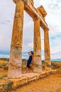 Ancient columns in Hierapolis, Pamukkale, Turkey and beautiful woman tourist Royalty Free Stock Photo