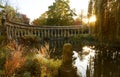 The ancient columns of Parc Monceau are reflected in the water of the oval basin, in the sun . This public garden is located in Royalty Free Stock Photo