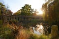 The ancient columns of Parc Monceau are reflected in the water of the oval basin, in the sun . This public garden is located in Royalty Free Stock Photo