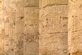 Ancient columns in a row with carved egyptian hieroglyphics Royalty Free Stock Photo