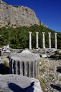 Ancient columns at the temple of Athena under a blue sky.