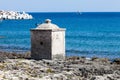 Ancient concrete construction on the beach in the port of Santa Maria di Leuca in southern Italy. Sea in the background Royalty Free Stock Photo