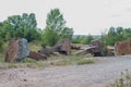 Ancient concrete huge columns made of stone, with metal elements. Against the background of the forest. Environmental pollution Royalty Free Stock Photo