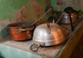 ancient copper pot and aluminum colander of a rural house