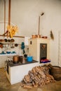 Ancient copper tableware stands in the kitchen on a larger antique oven, castle interiors, Bitov castle