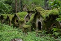 Ancient cottages covered in moss in a gnome village Royalty Free Stock Photo