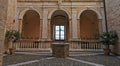 Ancient courtyard with arches well and window with panorama