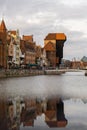 Ancient crane - zuraw Old town in Gdansk. The riverside on Granary Island reflection in Moltawa River. Visit Gdansk