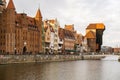 Ancient crane - zuraw Old town in Gdansk. The riverside on Granary Island reflection in Moltawa River. Visit Gdansk