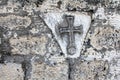 Ancient cross on the wall of ruined Greek Orthodox Church