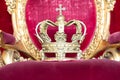 Ancient crown on red velvet. Antique symbol of authority, luxury, monarchy, nobility