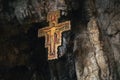 Ancient Crucifix hanging from the top of a cavern Royalty Free Stock Photo