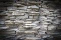 Ancient crumbling fortress wall of white flat protruding limestones