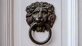 Ancient dark Doorknob in the shape of a Lion at white door