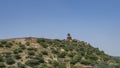 The ancient defensive fortress wall is visible on the ridge of the mountain.