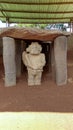 An ancient dolmen anthropo-zoomorphic sculpture a fish in its hands and anthropomorphic sculptures sides at Colombian San Agustin