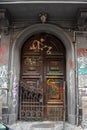 Ancient door defile by graffiti