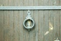 Ancient door handle ring on a wooden door