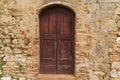 Ancient door of a house in the medieval center of San Gimignano Royalty Free Stock Photo
