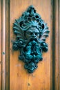 Ancient door knocker on a wooden door in Florence Royalty Free Stock Photo