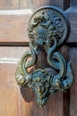 Ancient door knocker on a wooden door Royalty Free Stock Photo