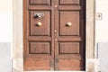An ancient door in a main street of Pisa, Italy