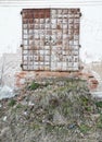 Ancient doors of the monastery with a ruined staircase.The ramshackle walls were overgrown with grass.Metal-bound door