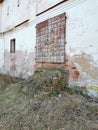 Ancient doors of the monastery with a ruined staircase.The ramshackle walls were overgrown with grass.Metal-bound door.