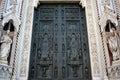 Ancient drak brown metal door window, Beautiful church entry to the house of christian god surrounding with white art statue Royalty Free Stock Photo