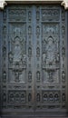 Ancient drak brown metal door window, Beautiful church entry to the house of christian god surrounding with white art statue Royalty Free Stock Photo