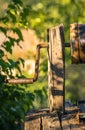 Ancient draw-well in European village, Old Water Well With Pulley and Bucket, Moldova, Green grass and trees. Sunny day. sunset Royalty Free Stock Photo