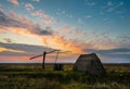 Ancient drawing well at sunset