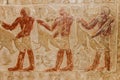 Ancient egyptian paintings and hieroglyphs carved on the stone wall