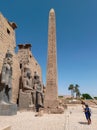 Ancient egyptian temple with an obelisk full of hieroglyphics and statues Royalty Free Stock Photo