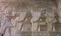 Ancient egyptian temple wall with hieroglyphic carving paintings Royalty Free Stock Photo