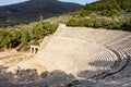 Ancient Epidauros amphitheater in Greece near Lighourio city at early sunset and tourists at the stage