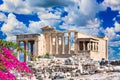 Ancient Erechtheion or Erechtheum temple with Caryatid Porch and pink Bougainvillea flower on the Acropolis, Athens, Greece. World Royalty Free Stock Photo