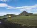Ancient farm houses near the Hvanngil camp site with green storasula montain onLaugavegur hiking trail, Highlands of