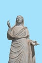 Ancient female statue on blue background. Minimal art concept