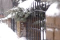 Ancient forged fence made of metal and stone in winter Royalty Free Stock Photo